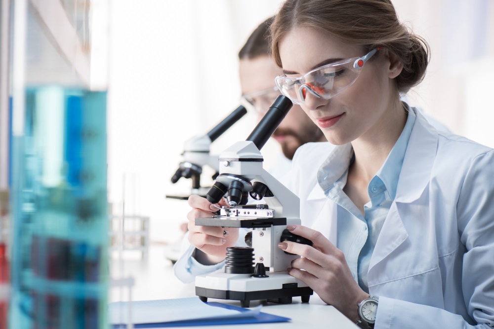 Female scientist working with microscope