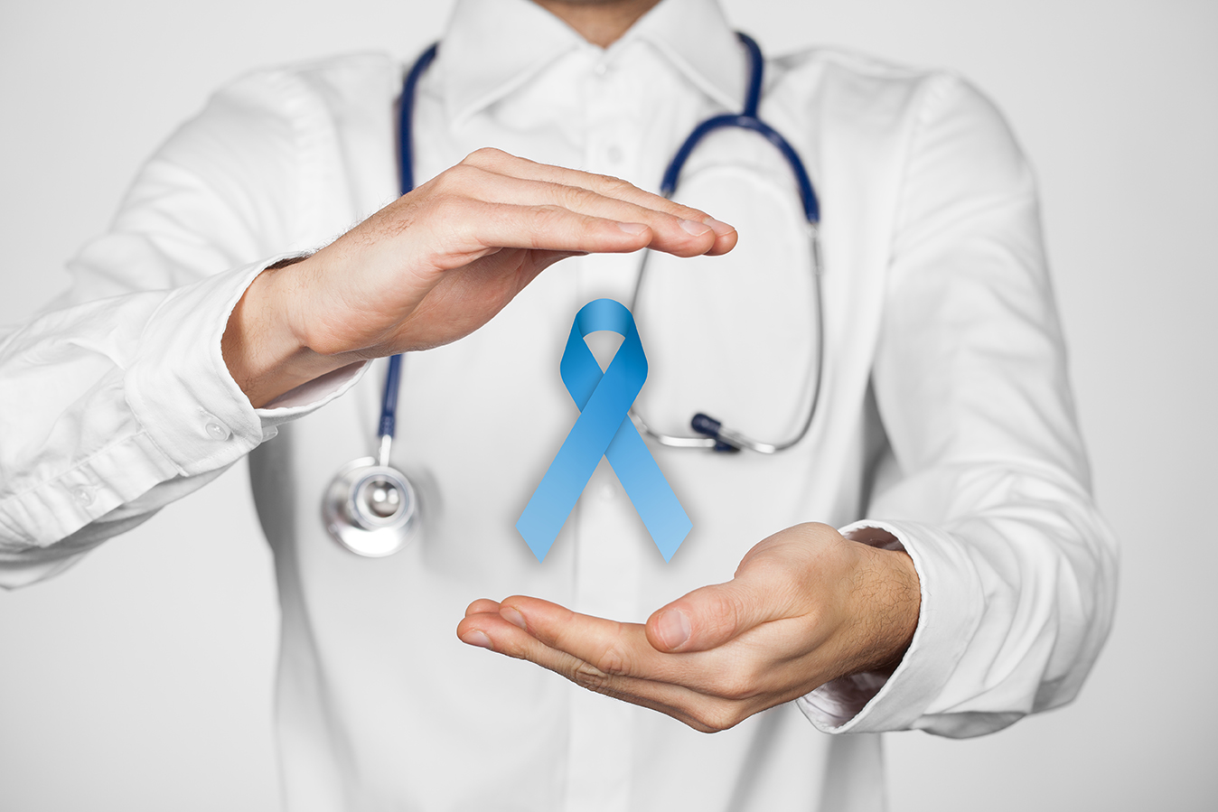 Prostate cancer prevention and genetic disorder awareness - doctor (general practitioner) with protective and support gesture and blue ribbon.
